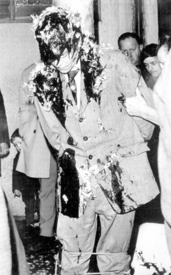 A youth tarred and feathered tied to a lamp post in the Falls Road area of Belfast. He is one of three who received such treatment in the past 24 hours. Date: 10/01/1971