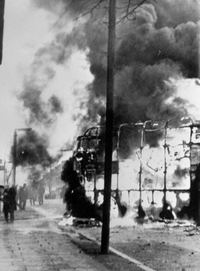 Flames leap into the air from a double decker bus when rioters used it as a blazing barricade in the Roman Catholic Falls Road area of Belfast. Violence broke out in Springfield Road after police and troops carried out an arms Date: 03/02/1971