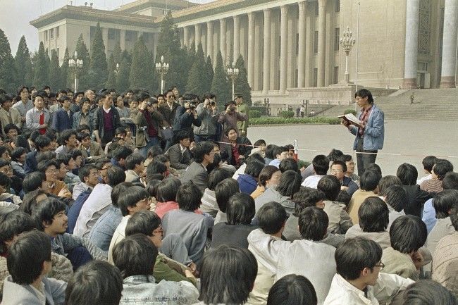 In this April 18, 1989 file photo, a Chinese student leader reads a list of demands to students staging a sit-in in front of Beijing's Great Hall of the People. A quarter century after the Communist PartyÂs attack on demonstrations centered on Tiananmen Square on June 4, 1989, the ruling party prohibits public discussion and 1989 is banned from textbooks and Chinese websites. (AP Photo/Kathy Wilhelm, File)
