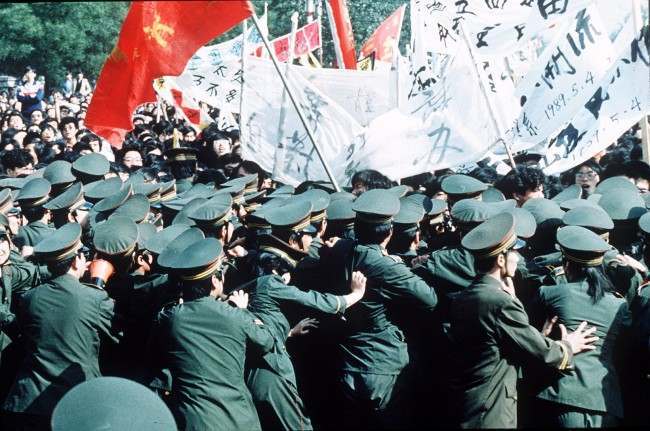 Chinese police try in vain to contain a huge crowd of student marchers during a pro-reform demonstration in Beijing, China, May 4 1989. (AP Photo/S. Mikami)