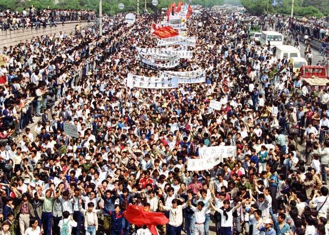 More than seven thousand students from local colleges and universities march to Tiananmen Square, Beijing, May 4, 1989, to demonstrate for government reform. (AP Photo/Mikami)