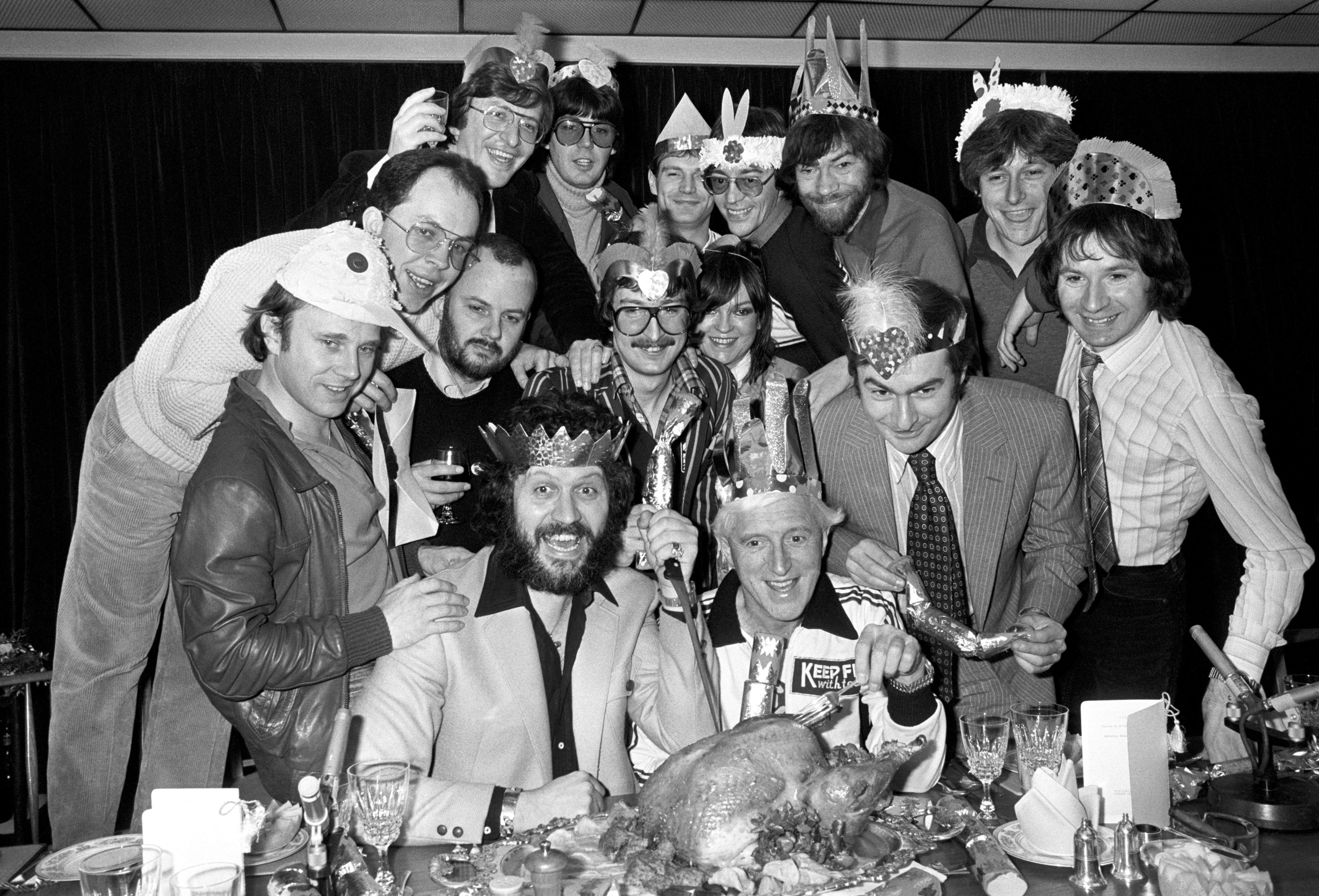 A group of fifteen of radio's best-known disc jockeys eating Christmas Lunch at Broadcasting House in 1980. Back L/R Simon Bates, Mike Read, Peter Powell, Tommy Vance, Adrian Love and Richard Skinner. Middle L/R Paul Burnett, Andy Peebles, John Peel, Steve Wright, Annie Nightingale, Paul Gambaccini, and Adrian Juste. Front L/R Dave Lee Travis and Jimmy Saville.