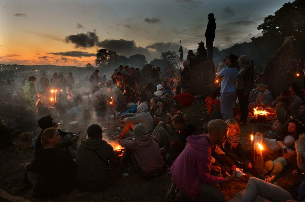 Festival-goers relax near the stone circle as the sun rises following the final day of the Glastonbury 2013 Festival of Contemporary Performing Arts at Pilton Farm, Somerset 01/07/2013 Picture by: Anthony Devlin/PA Archive/Press Association Images Image Size: 4096x2726