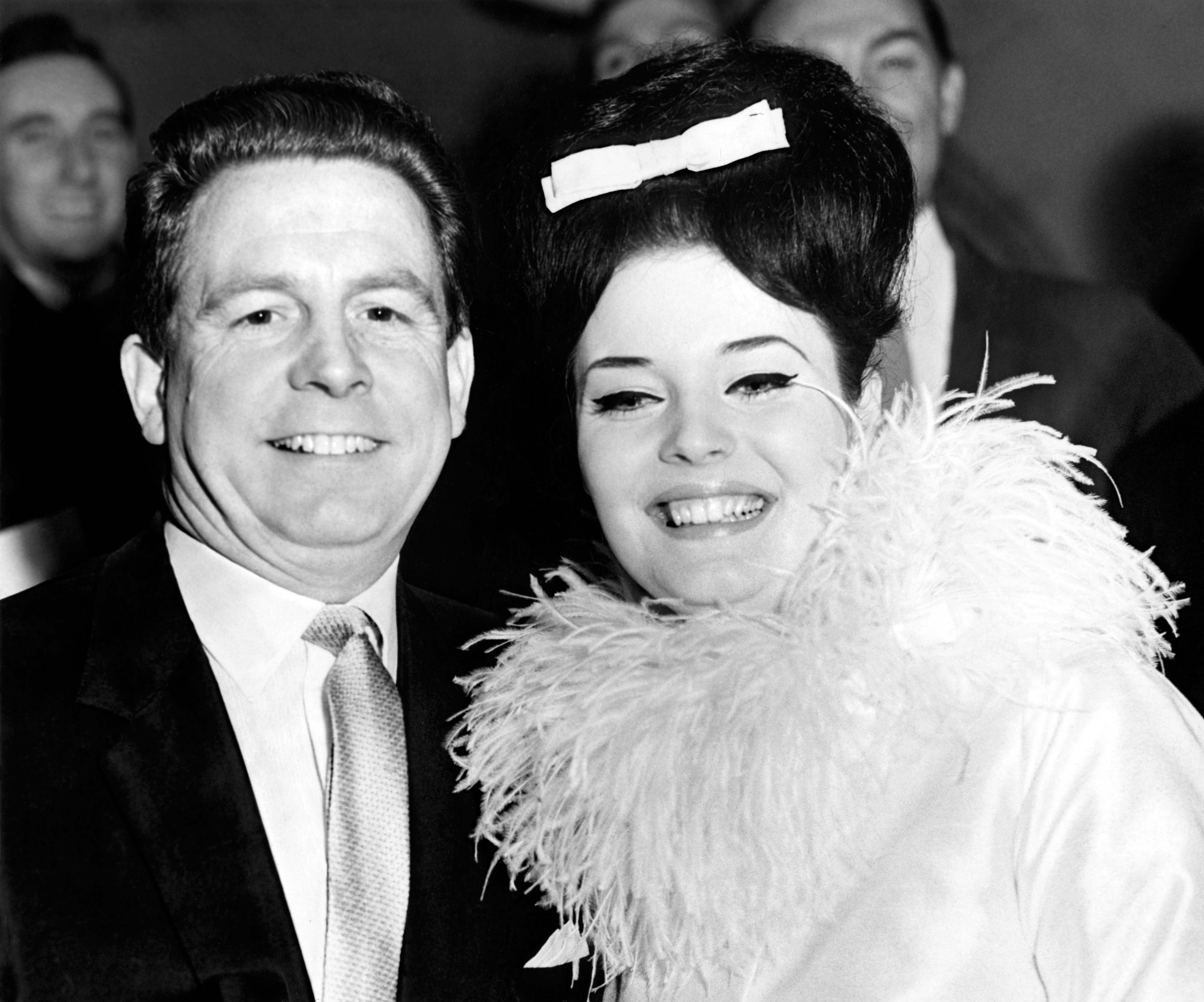 20 year old 1961 Miss World Rosemarie Frankland and her new husband Ben Jones, a journalist and sixteen years her senior, leave after the ceremony at Caxton Hall. The marriage was unable to survive her hectic lifestyle (ie having an affair with Bob Hope) and he filed for divorce six months later on the grounds of adultery.