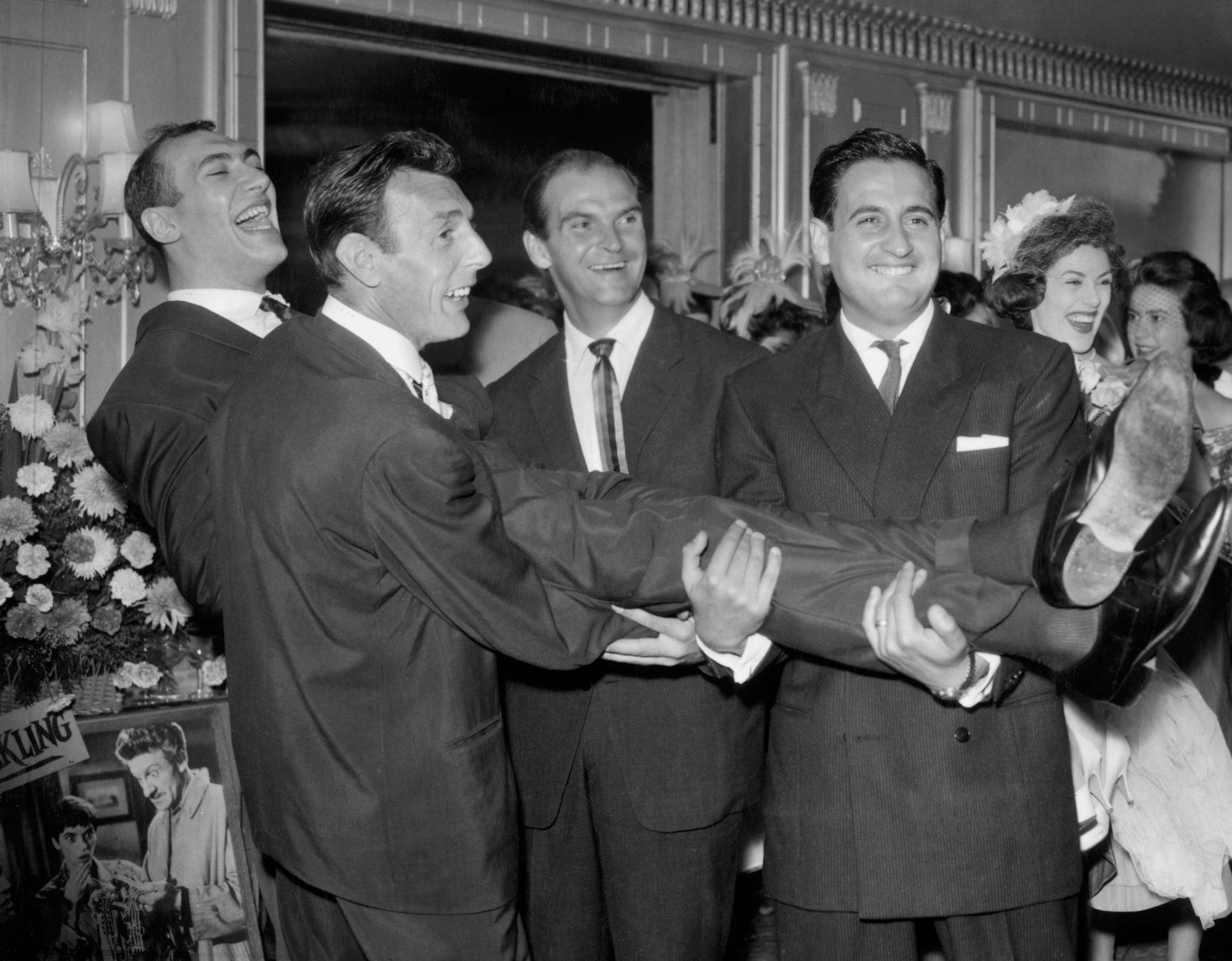 Bernard Bresslaw, 25, after his wedding to dancer Elizabeth Wright at Caxton Hall on 8 August 1959. Carrying Bresslaw, left to right, are; comedian Eric Sykes, actor Stanley Baker and comedian Bernie Winters. The couple remained married, with three children, until Bresslaw died in June 1983.