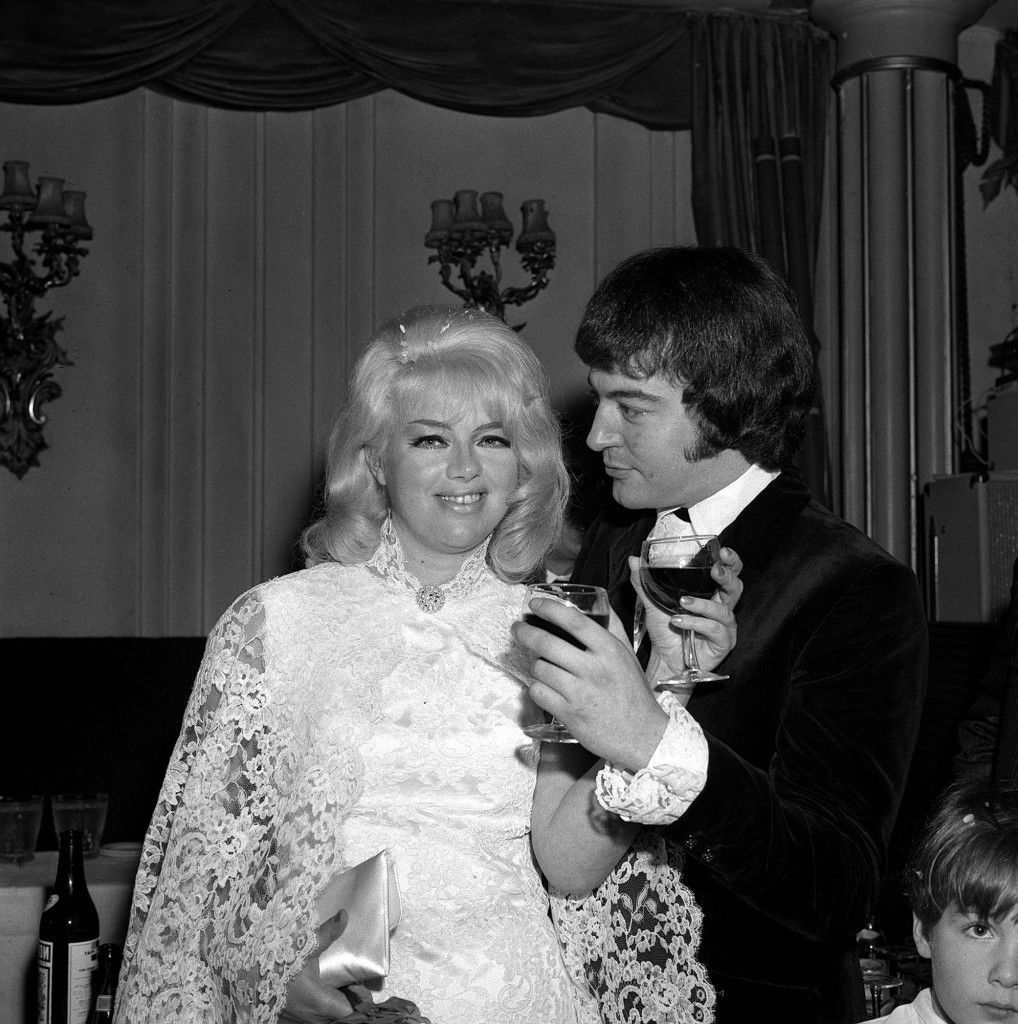 Diana Dors and her bridegroom Alan Lake exchange toasts at the reception at the Astor Club, after their wedding at Caxton Hall on 23 November 1968. They remained married until Dors' death in 1984.