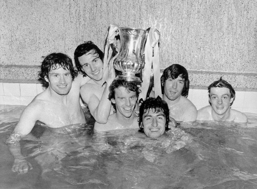 Splashing out after their 3-2 win over Manchester United in this afternoon's FA Cup Final at Wembley. Arsenal players (from left): Pat Rice (captain), Frank Stapleton, Graham Rix, Brian Talbot, Pat Jennings and David O'Leary take a well-earned bath, making sure to keep their victors' trophy high and dry Ref #: PA.13092261  Date: 12/05/1979 