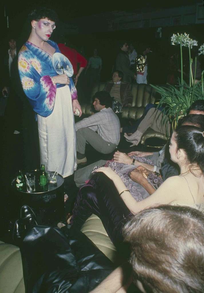 Brightly attired patron uses a fan to cool off in the lounge at New York's Studio 54, March 1979. (AP Photo)