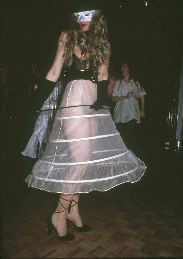 A woman wearing a hoop petticoat and mask poses at New York's Studio 54, March 1979. (AP Photo)