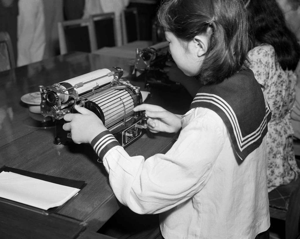A new Japanese typewriter invented by Kotaro Kataoka, an employee of the Tokyo Electric Company, was demonstrated by a school student in Tokyo on August 31, 1949. The machine, smaller and lighter than the standard English language typewriter has the type cased on a cylindrical bed instead of the former Japanese flat bed in use. The new machine contains 1,132 characters in comparison to the old type which had 3000. (AP Photo/Charles Gorry) Ref #: PA.11669475 