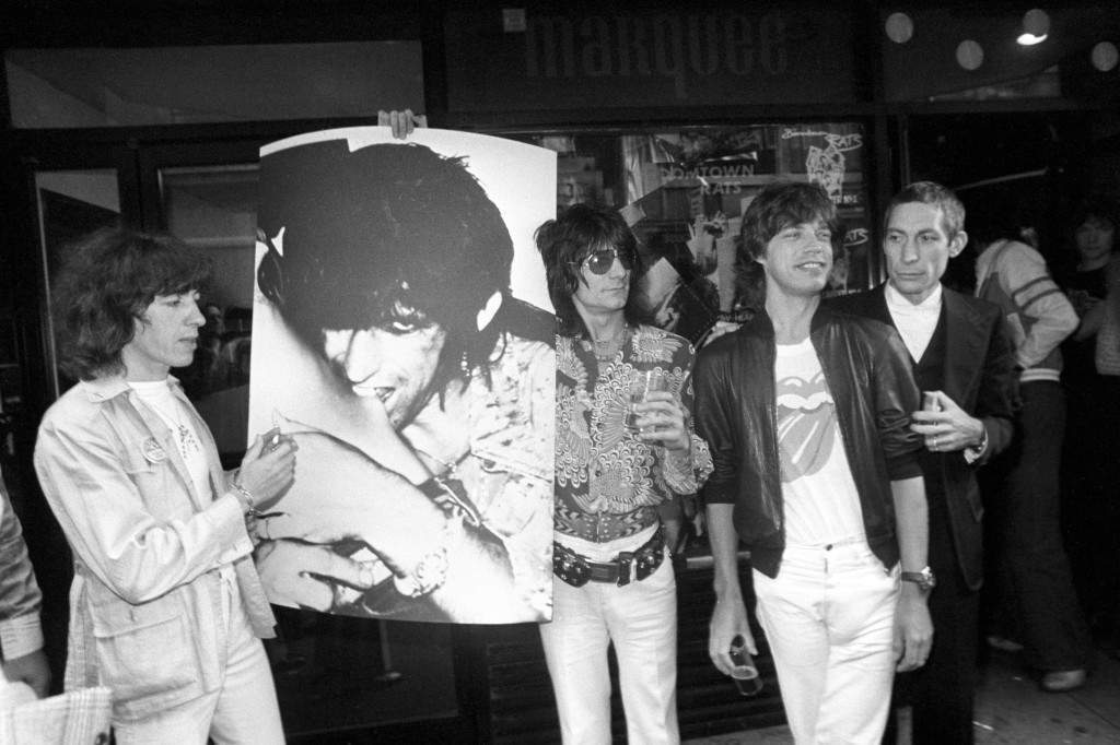 Rock group The Rolling Stones (Bill Wyman - left- a poster of missing member Keith Richards who is detained in Canada on drugs charges; Ronnie Wood, Mick Jagger and Charlie Watts) launch their new live album "Love You Live," recorded in Toronto and Paris. Ref #: PA.12651927  Date: 14/09/1977