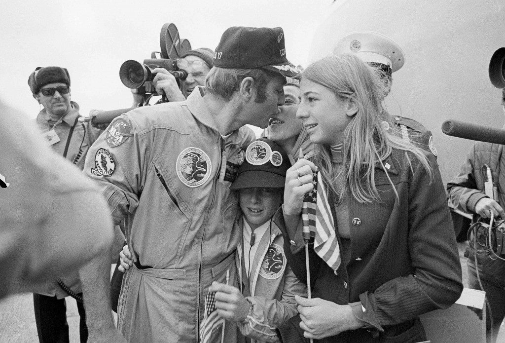 Apollo 17 command module pilot, Ronald E. Evans, is greeted by his family after the crew landed at Ellington Air Force Base, Houston, Texas, Dec. 21, 1972. Evans is sown kissing his wife, Jan, as daughter, Jaime, 13, waits her turn to kiss her dad. Son Jon, 11, is squeezed in by the trio. Evans, a commander in the U.S. Navy when he left for the moon, was promoted to captain on his return to earth. (AP Photo) Ref #: PA.15718094  Date: 21/12/1972