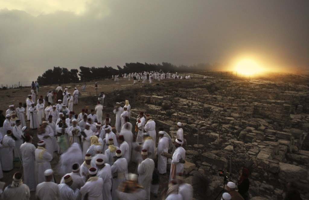 Members of the ancient Samaritan community pray during the pilgrimage for the holy day of the Tabernacles or Sukkot at the religion's holiest site on the top of Mount Gerizim near the West Bank town of Nablus, early Thursday Oct. 25,2007. According to tradition, the Samaritans are descendants of Jews who were not deported when the Assyrians conquered Israel in the 8th century B.C. Of the small community of close to 700 people, half live in a village at Mount Gerizim, and the rest in the city of Holon near Tel Aviv. (AP Photo/Kevin Frayer) Ref #: PA.5278274  Date: 25/10/2007