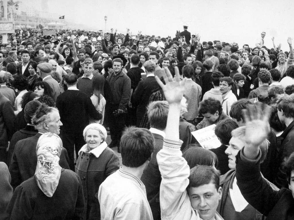 White helmeted policemen are lost in the surging crowd at the seafront, Brighton. After yesterdays battles at Margate Mods and Rockers desended on Brighton. Ref #: PA.5581342  Date: 18/05/1964 