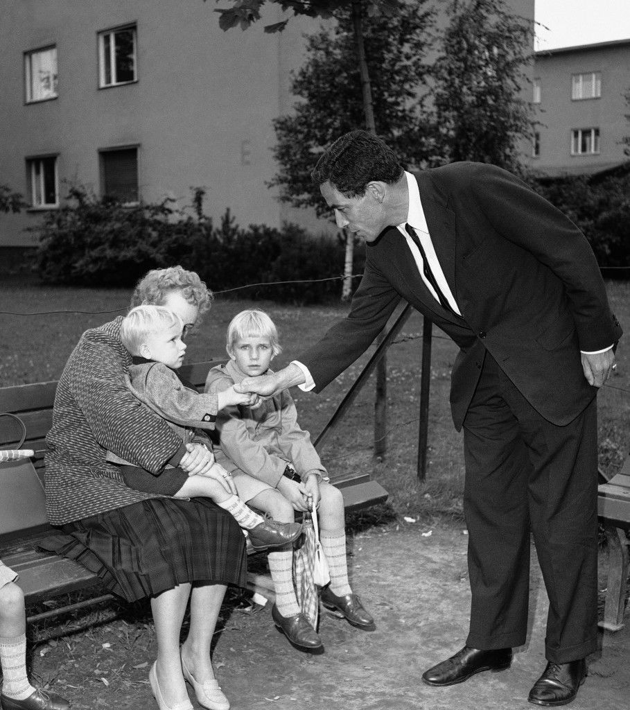 Sen. Claiborne Pell (D-Rhode Island) talks with a mother and two children, all three newly arrived refugees from communist East Germany. The conversation took place during Pell's visit on July 22, 1961 of West Berlin's largest refugee center, Marienfelde. (AP Photo/Reichert) Ref #: PA.7278691  Date: 22/07/1961