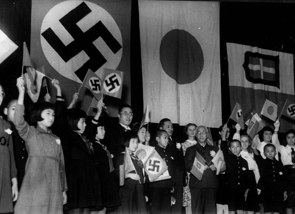 Children of Japan, Germany, and Italy meet in Tokyo to celebrate the signing of the Tripartite Alliance between the three nations, December 17, 1940. Japanese education minister Kunihiko Hashida, center, holding crossed flags, and Mayor Tomejiro Okubo of Tokyo were among the sponsors. (AP Photo) Ref #: PA.8632668  