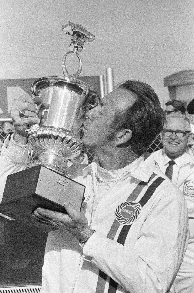 Red Farmer, of Hueytown, Alabama, plants a big kiss on the trophy presented him for winning the Permatex 300 stock car race at the Daytona International Speedway. Farmer drove his 1968 Ford to win the event, his first victory at Daytona Beach on Feb. 13, 1971. (AP Photo/George Brich) Ref #: PA.9020952  Date: 13/02/1971