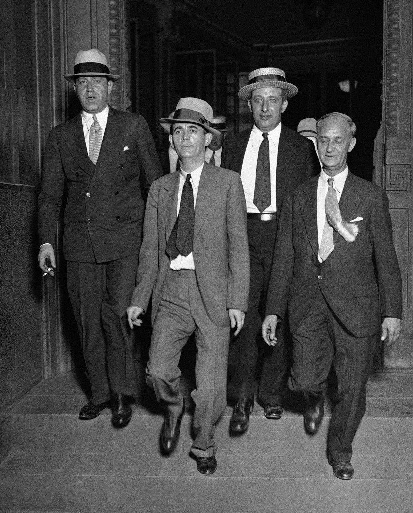 Jack "Legs" Diamond, center, and his attorneys, leaving the Federal Court in New York on August 8, 1931, after his conviction of owning an unlicensed still and conspiring to violate the prohibition law. The jury deliberated slightly more than two hours before returning its verdict. Under the terms of the law Diamond is subject to maximum sentence of four years in federal prison and a combined fine of $11,000. (AP Photo) Ref #: PA.9966469  Date: 08/08/1931