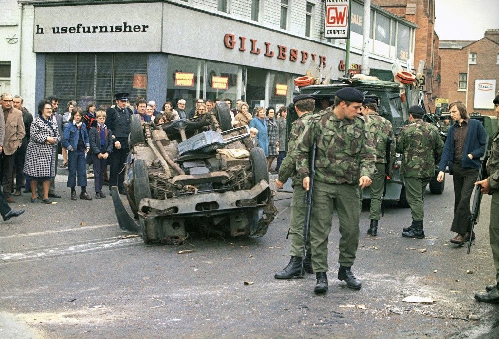 British troops prepare to move an overturned and wrecked car, used as a barricade in Newtownwards Road in Belfast, capital of Northern Ireland in May 1974, during the strike called by members of the Ulster Workers Council. (AP Photo) Ref #: PA.10990748 