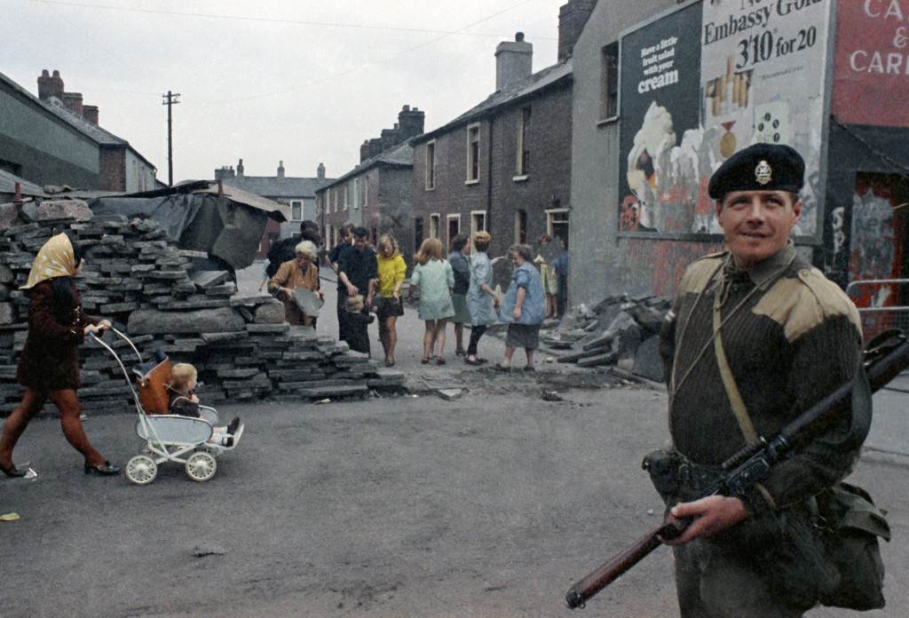 An armed British soldier in Belfast, Northern Ireland during disorders in September 1969. In the background are local people. (AP Photo/Royle) Ref #: PA.11408246  Date: 14/09/1969 