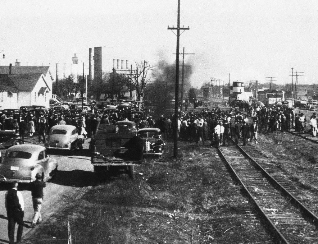 Smoke rises from the burning body of Cleo Wright, African American, suspected of attempted rape of a white woman. He was taken from the city hall of Sikeston, Missouri on Jan. 25, 1942, already injured by an arresting officer, and was burned by a mob. (AP Photo)