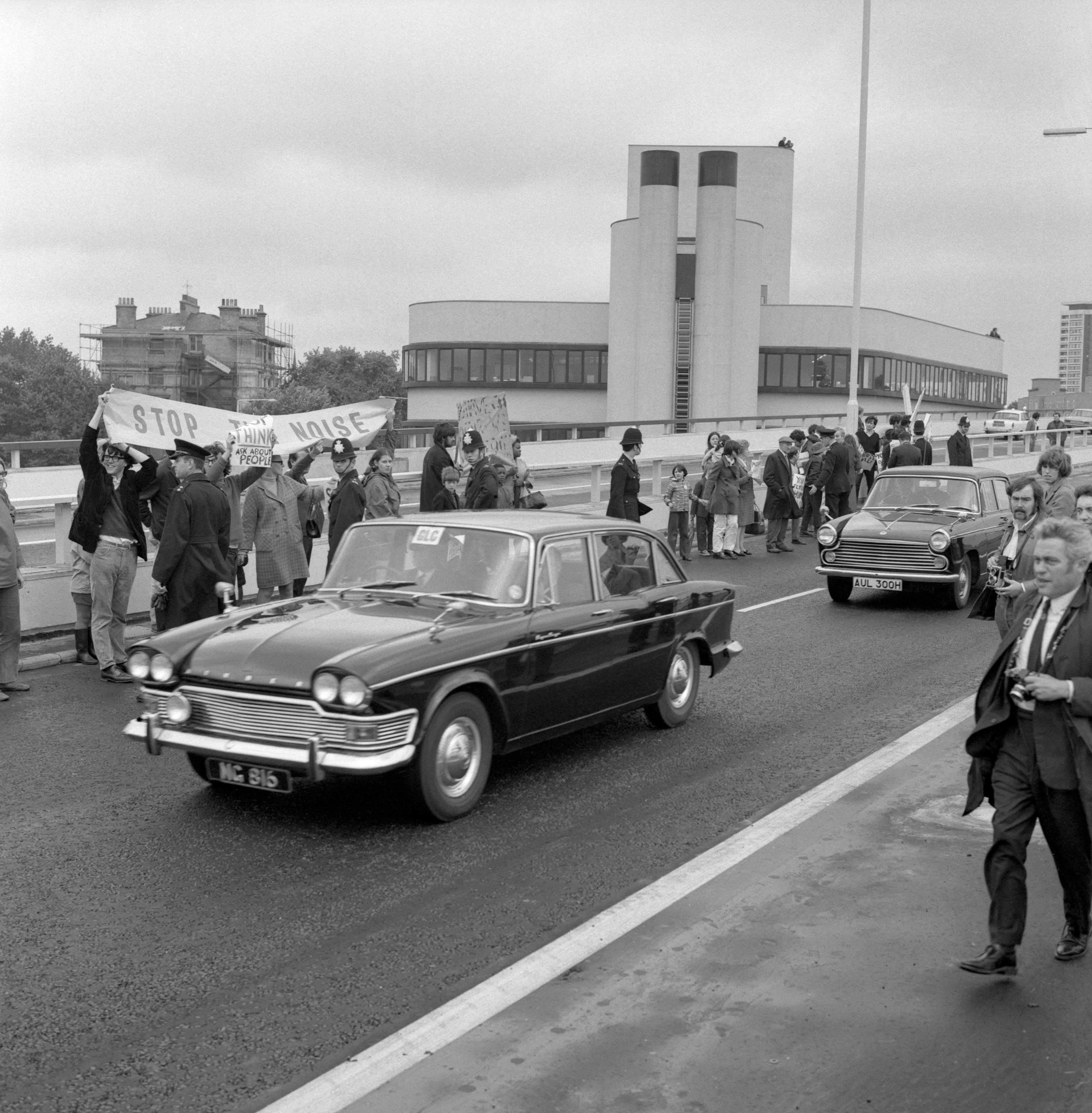 A Ministry of Transport cars drive along the new Western Avenue Extension, as residents of nearby flats hold their banners in protest. The 2.5 mile long Western Avenue Extension, Britain's longest elevated road. The 2.5 mile long 'Westway', Britain's longest elevated road, is a section of the A40 route in west London and runs from Paddington to North Kensington. It was built to relieve congestion at Shepherd's Bush caused by traffic from Western Avenue.
