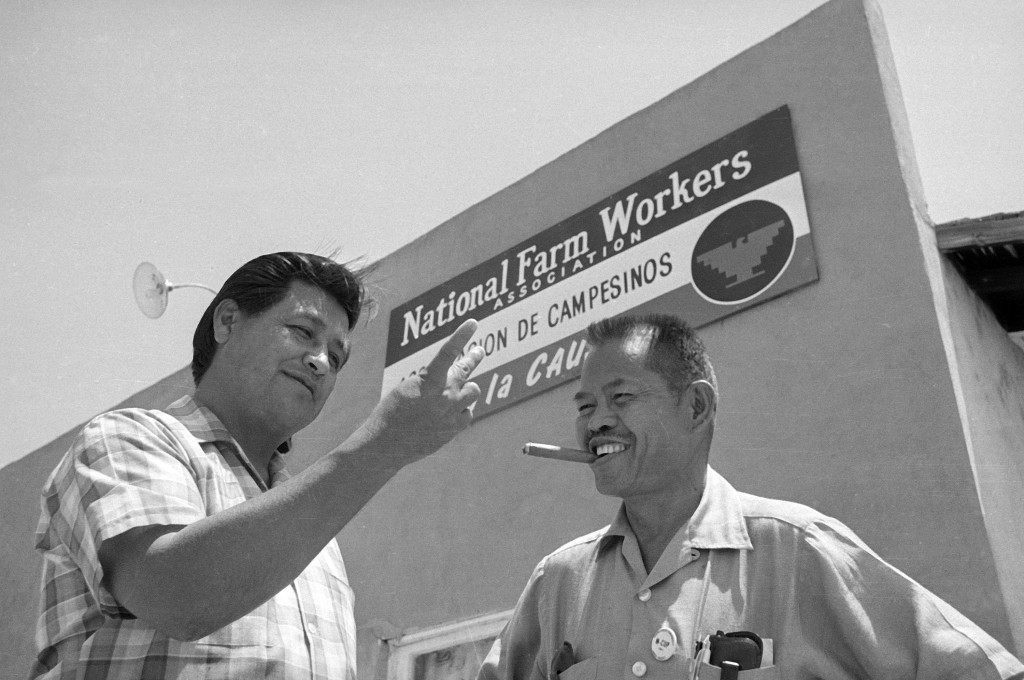 United Farm Workers leader Cesar Chavez, left, who led the fight as head of the AFL-CIO union local, talks with his assistant Larry Itliong, in front of union headquarters at Delano, Calif., July 28, 1967. (AP Photo/Harold Filan)