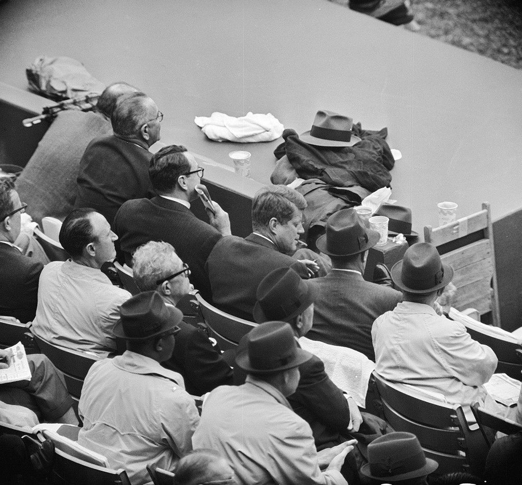 President John F. Kennedy enjoys a cigar while watching a baseball game between the Washington Senators and the Detroit Tigers in Washington April 10, 1962. (AP Photo)