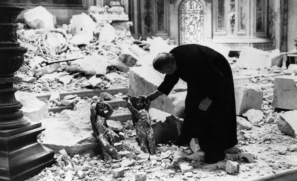 One of the clergy of St. Paul?s cathedral in London looks at two cherubs standing among the debris and holding their heads as though for protection, Oct. 10, 1940 in London. The destruction was caused by a bomb. St. Paul's cathedral in London, Eng. (AP Photo)
