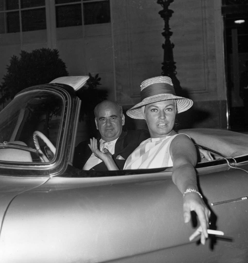 Swedish actress Anita Ekberg is photographed in a sports car with Hollywood film producer Sydney Pink after they went nightclubbing in Rome, Italy, Aug. 11, 1961. (AP Photo/Ivan Croscenco)
