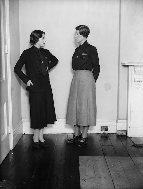 November 1933: Mrs Swire a leading figure in the women’s section of the British Union of Fascists wears the new uniform of grey skirt with black shirt talks to a member of the HQ staff in London who wear all black. Mosley was afraid the women members might jokily be called the ‘black skirts’.