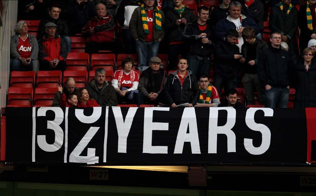 MANCHESTER, ENGLAND - FEBRUARY 12:  Manchester United fans display a banner depicting the last time City won a trophy during the Barclays Premier League match between Manchester United and Manchester City at Old Trafford on February 12, 2011 in Manchester, England.  (Photo by Alex Livesey/Getty Images)