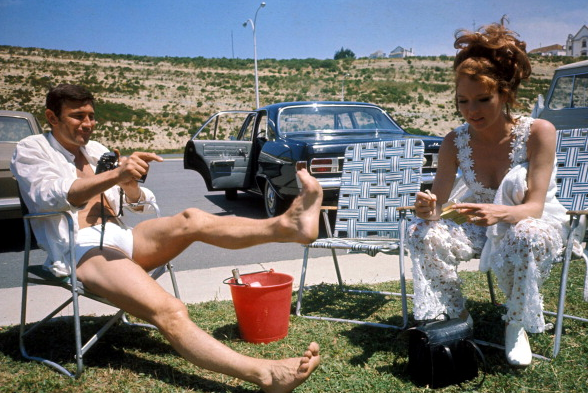 Australian actor George Lazenby and English actress Diana Rigg relax on the set of the James Bond film 'On Her Majesty's Secret Service', 1969.