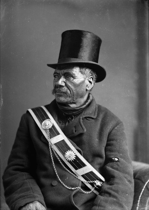 Cabinet card portrait of Horonuku Te Heuheu IV, wearing a top hat and a sash, taken in the 1880s by Samuel Carnellof Napier.
