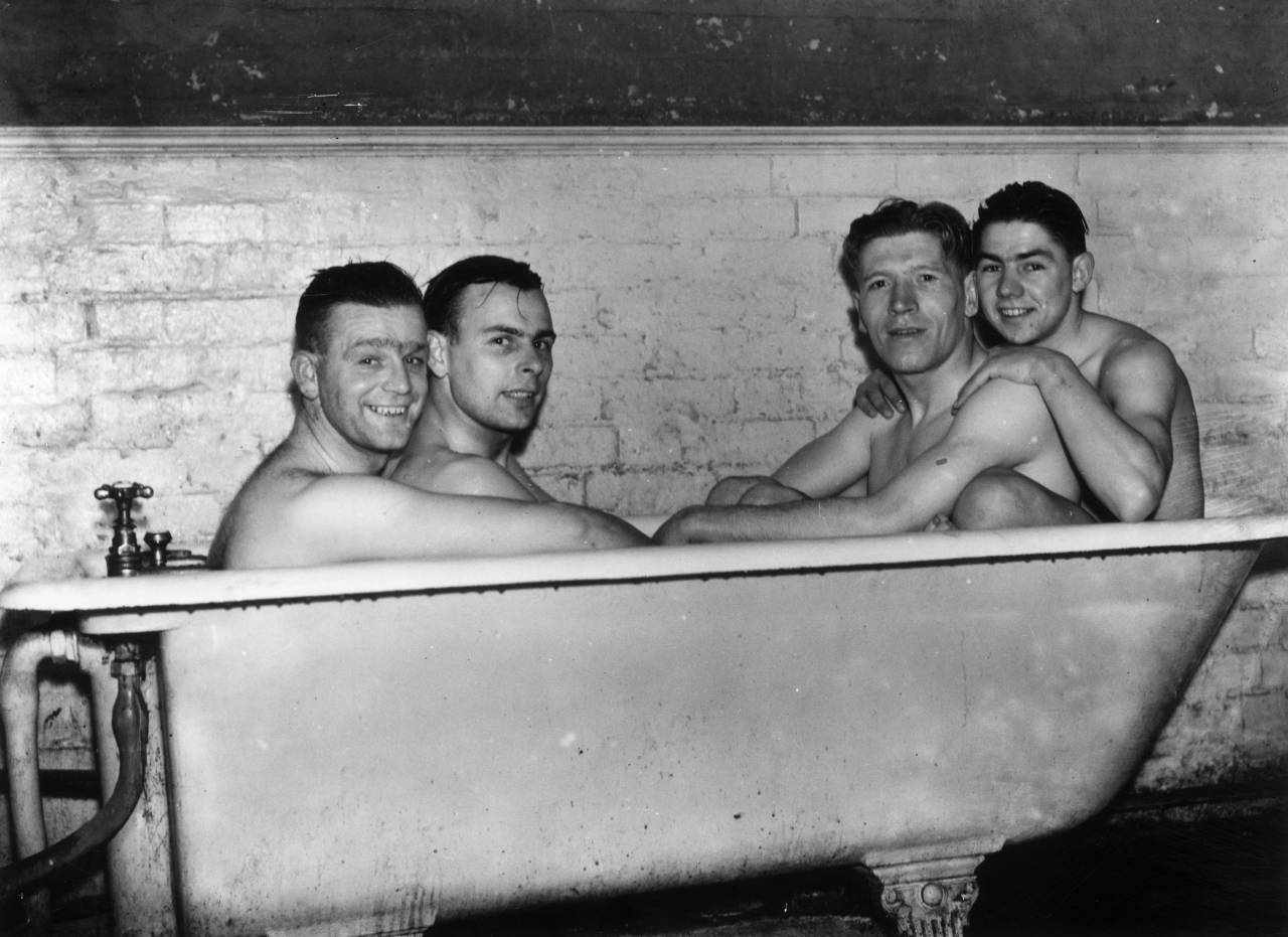 26th January 1937: Poyser, MacKenzie, McCulloch and Smith of Brentford Football Club share a cramped bath after a hard training session at Bushey Hall, Hertfordshire, in preparation for their FA Cup tie match against Derby County on Saturday. (Photo by G. Adams/Topical Press Agency/Getty Images)