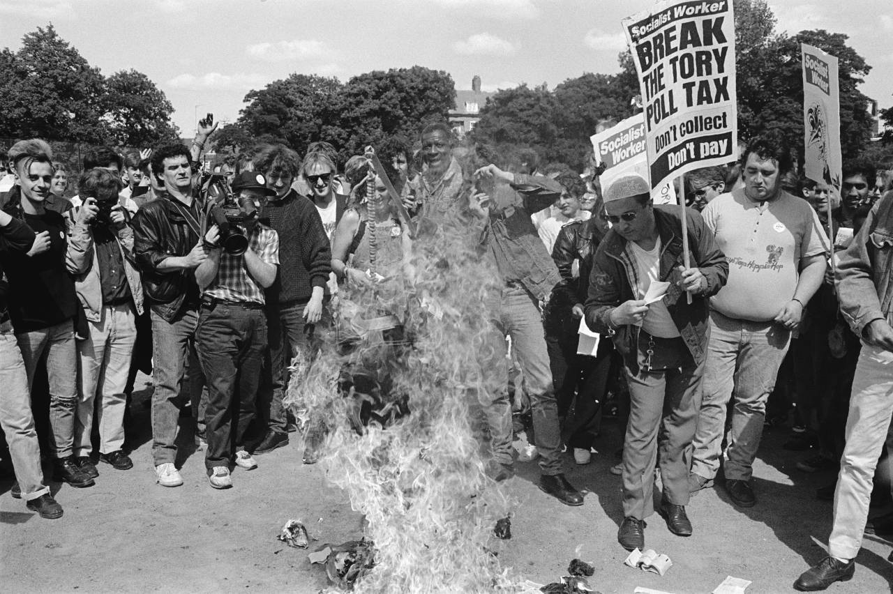 Protestors burn their Poll Tax documents in protest at what they see as an unfair levy, London, March 1990. (Photo by Steve Eason/Hulton Archive/Getty Images)