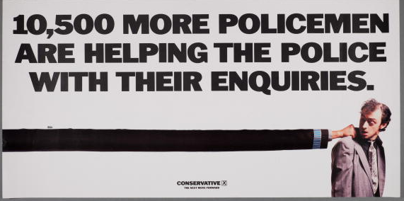 A poster for the British Conservative Party from the 1983 General Election. It depicts a row of wine bottles with the caption 'What are the SDP's policies? Ten bottles of claret can be won for the best guess. Write to Conservative Central Office, 32 Smith Square, London SW1P 3HH'.