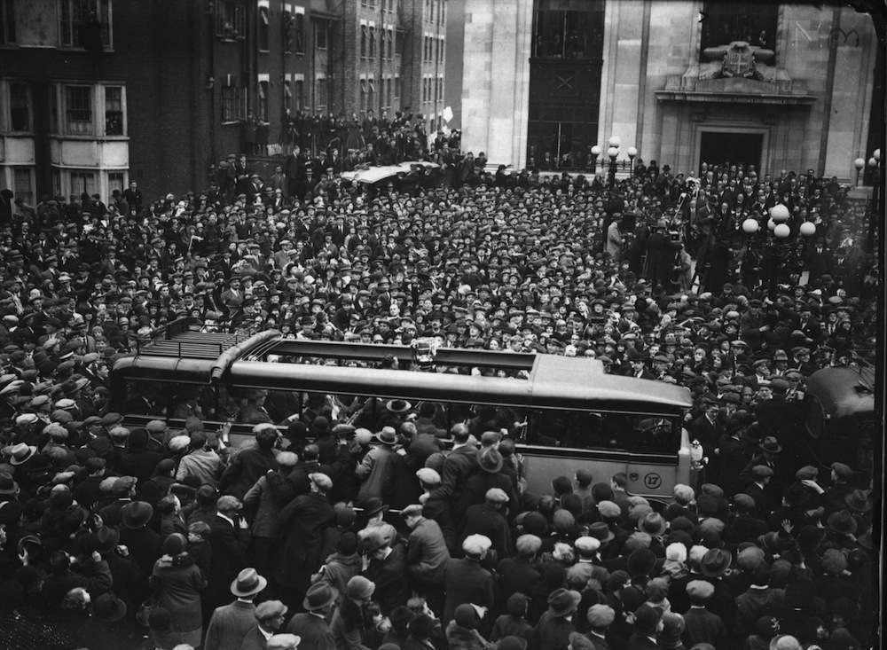 April 1930:  Crowds mob the victorious Arsenal football team as they arrive for a civic reception at Islington Town Hall given by the Mayor and Corporation of Islington. Arsenal defeated Huddersfield 2-0 In the FA Cup Final.  (Photo by Miller/Topical Press Agency/Getty Images)