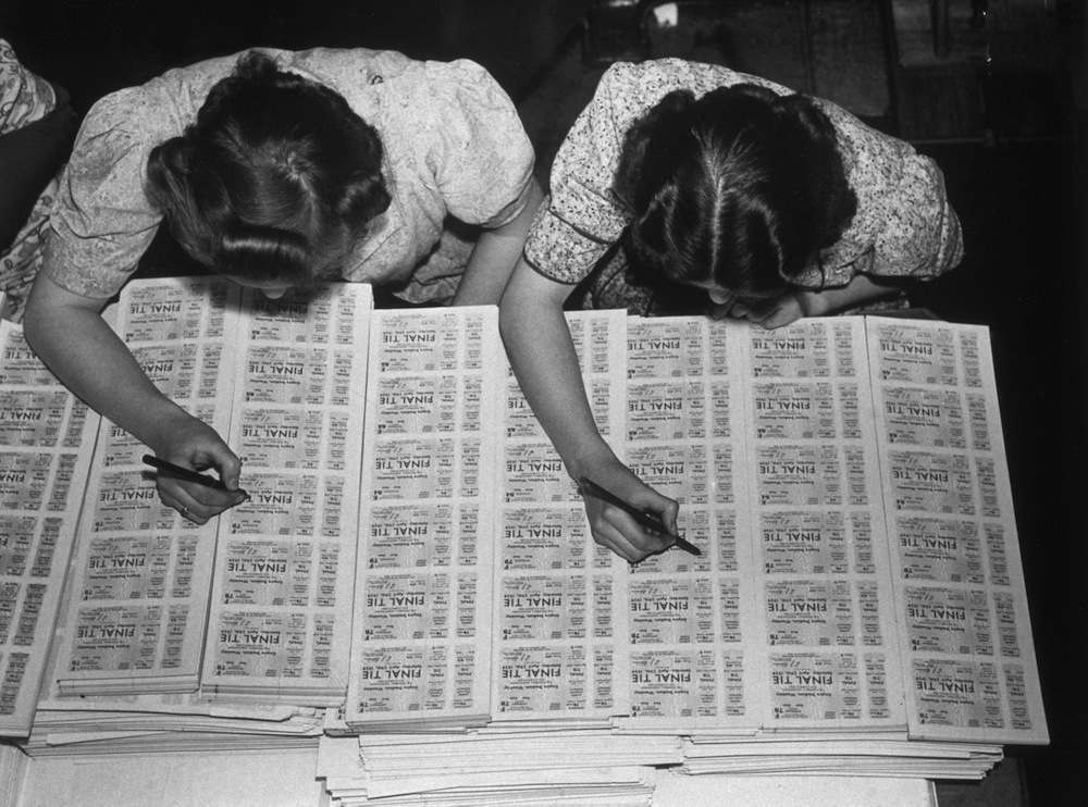 circa 1939: Two women checking FA cup final tickets at Messrs Waterlow's printing works in Finsbury, London. (Photo by Hulton Archive/Getty Images)