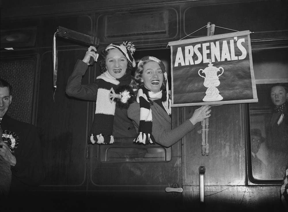 Arsenal F C supporters on the train at Euston Station on their way to support their team in an FA Cup tie against Burnley, 20th February 1937. (Photo by E. Dean/Topical Press/Getty Images)