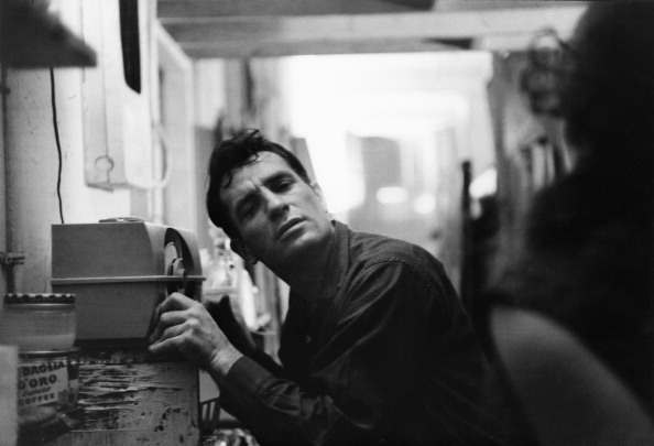 American Beat writer Jack Kerouac (1922 - 1969) leans closer to a radio to hear himself on a broadcast, 1959. (Photo by John Cohen/Getty Images)