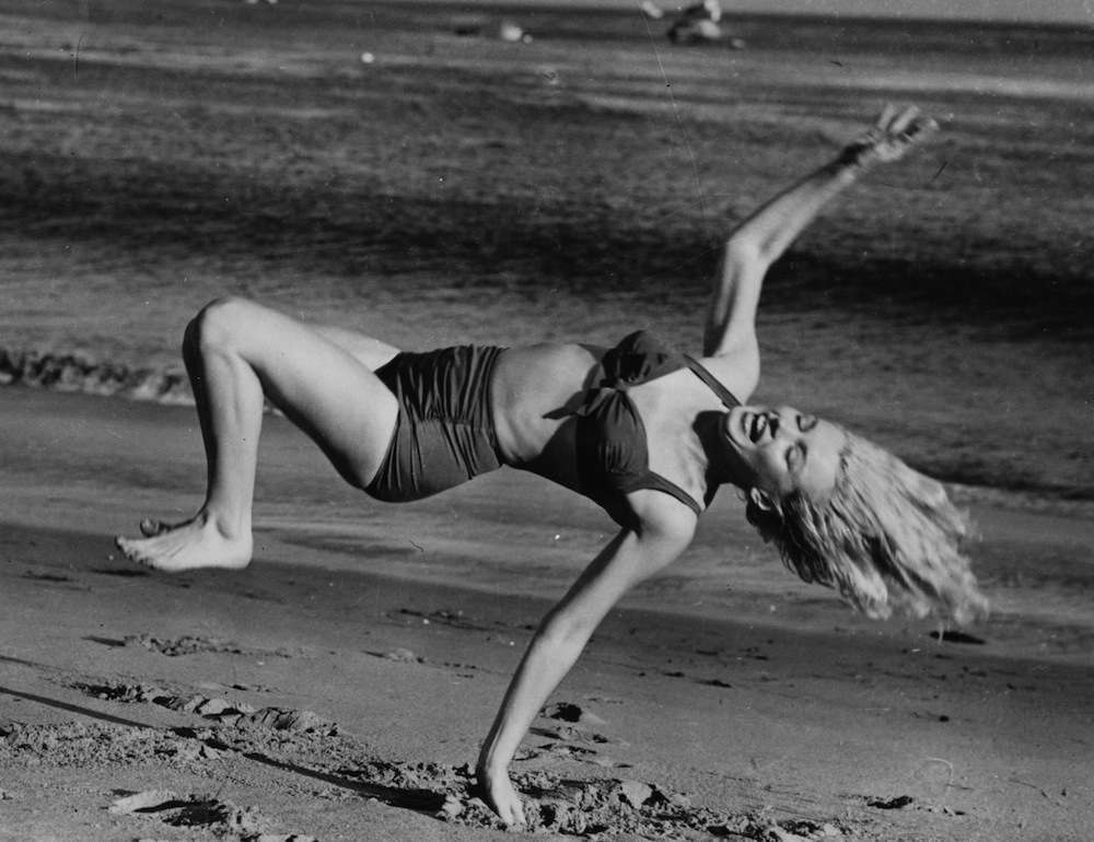 Marilyn Monroe (1926  - 1962) frolicking on the beach near her Hollywood home during a break from filming.   (Photo by L J Willinger/Getty Images)