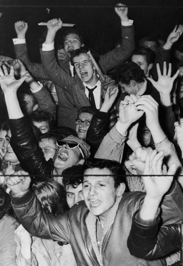 Germany's youth cheer on Bill Haley and the Comets at a rock 'n' roll concert at the Berlin sportspalast. (Photo by Keystone/Getty Images)