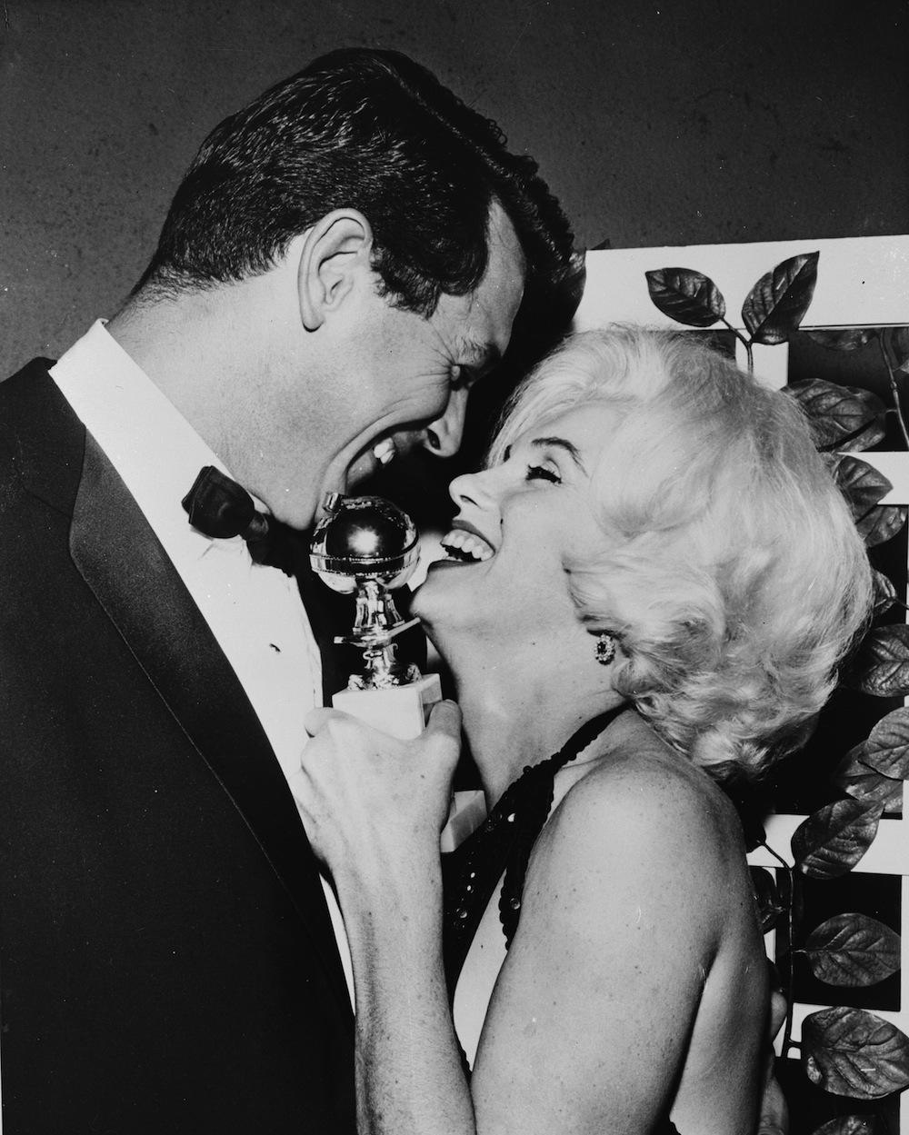 13th March 1962:  Marilyn Monroe (Norma Jean Mortenson or Norma Jean Baker, 1926 - 1962) receives her Golden Globe award from Rock Hudson (1925 - 1985) at the Hollywood Foreign Press Association's 19th Annual Dinner.  (Photo by Keystone/Getty Images)