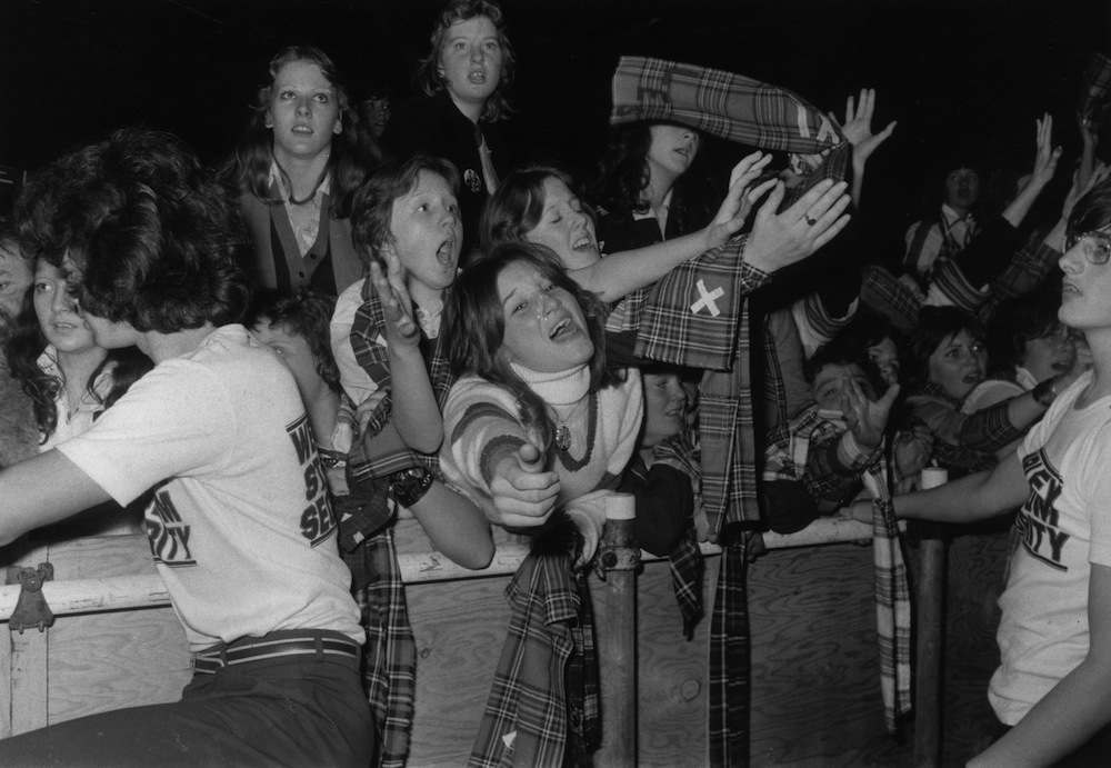 17th November 1975:  Stewards keep a watchful eye on the hysterical pop fans during a Bay City Rollers concert at Wembey Empire Pool, London.  (Photo by Monty Fresco/Evening Standard/Getty Images)