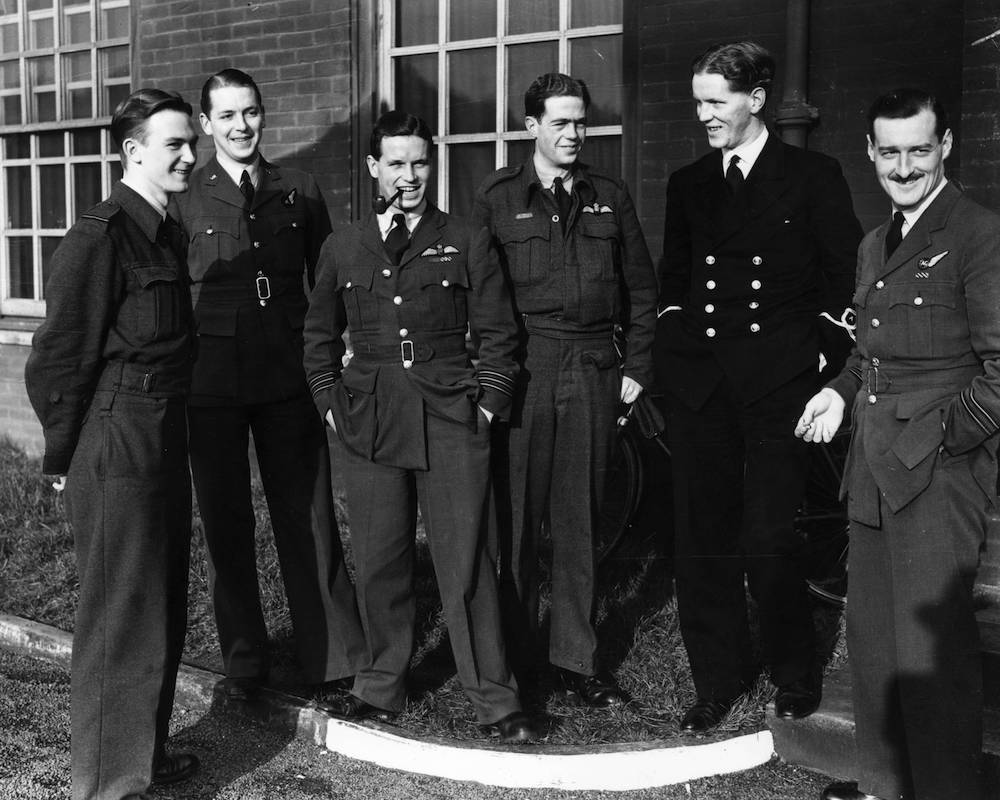 January 1943: Wing Commander Guy Gibson (smoking pipe), and members of his Lancaster bomber air crew after a bombing raid on Berlin. Gibson later led the 'Dambusters' raid. (Photo by Central Press/Getty Images)