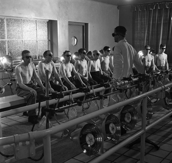 The first year of Coal Nationalisation brought in many new schemes aimed at improving productivity and a healthy workforce, such as this +sunlight+ therapy session, Under the guidance of a qualified Therapist Miners receive a dose of ultra violet and infra red rays from special lamps set up in this solarium, 16th December 1947 (Photo by Popperfoto/Getty Images)
