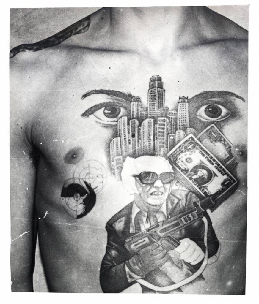 The man in this tattoo is a character from a TV crime series shown during the Soviet era – a brutal gang leader. In the story, he ends up in jail. In this tattoo, however, he defends himself against the Soviet power and fights back. On his submachine gun are the letters ‘US’ which along with the skyscrapers and dollar bills embody the ideological opponents of the Soviet Union and indicate a hatred of the government. The eyes signify that ‘I am watching over you’ (the other inmates in the prison or camp). The epaulette tattooed on the shoulder denotes the inmates ‘rank’ among the criminal caste. © Arkady Bronnikov / FUEL  