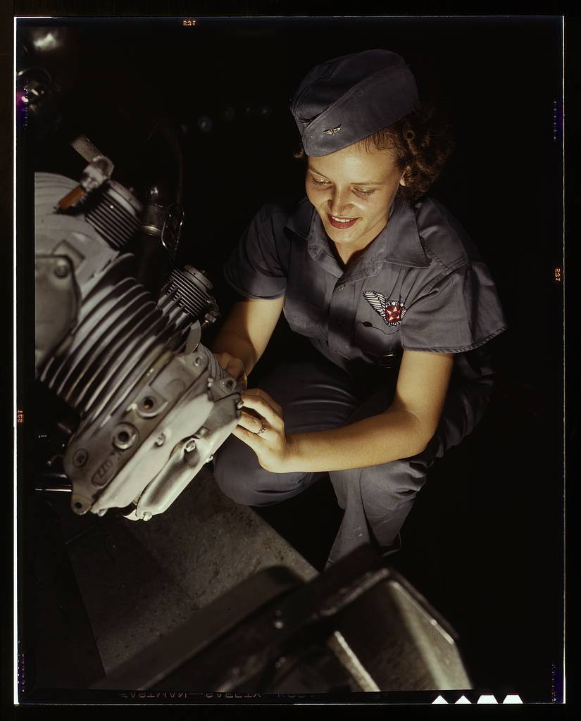 Assembly and Repairs Dept. mechanic Mary Josephine Farley works on a Wright Whirlwind motor, Naval Air Base, Corpus Christi, Texas