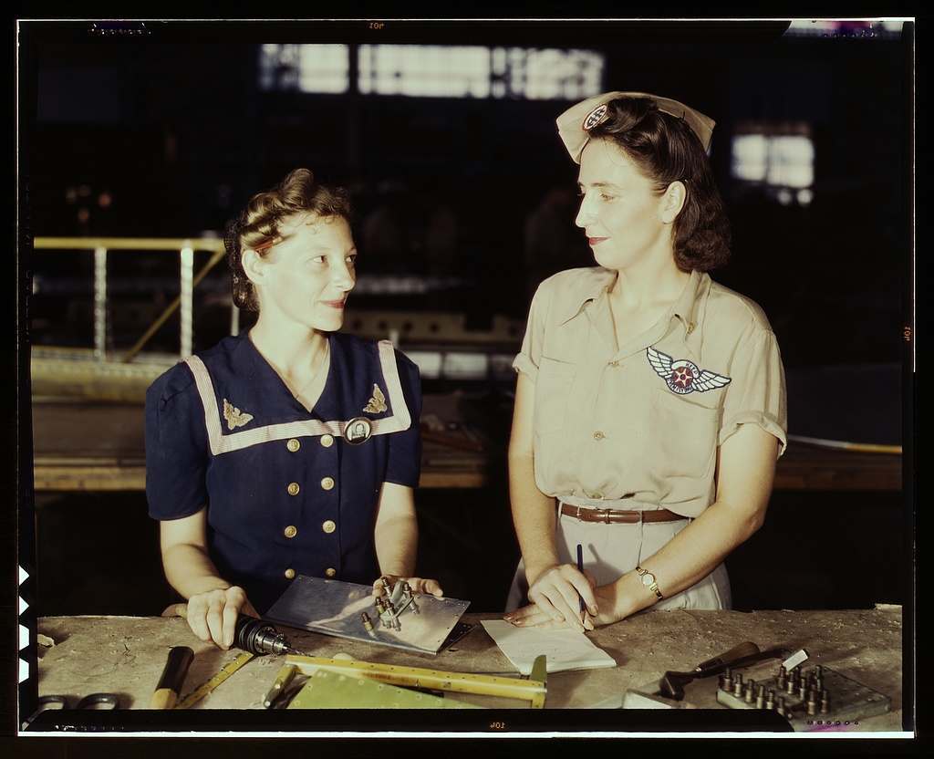 Pearl Harbor widows have gone into war work to carry on the fight with a personal vengeance, Corpus Christi, Texas. Mrs. Virginia Young (right) whose husband was one of the first casualties of World War II, is a supervisor in the Assembly and Repairs Department of the Naval Air Base. Her job is to find convenient and comfortable living quarters for women workers from out of the state, like Ethel Mann, who operates an electric drill